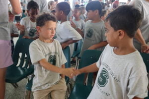 camp friendship handshake kids peace